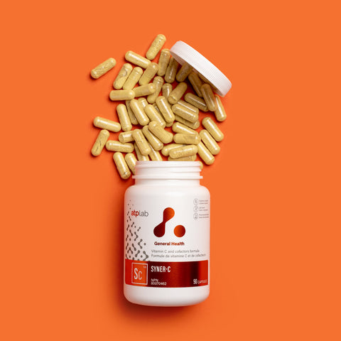 Syner-C supplement bottle by ATP LAB with some capsules on an orange background available at Healthsupp.
