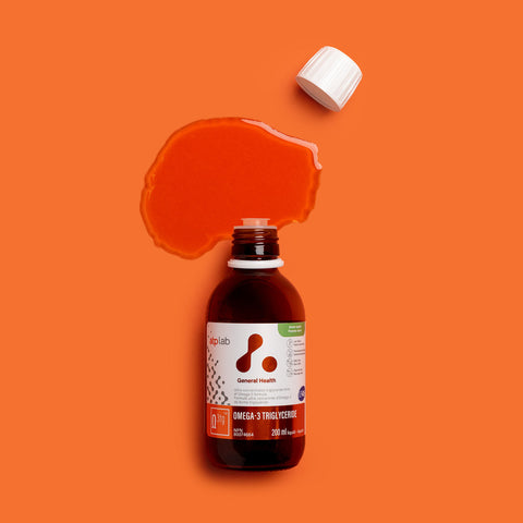 Bottle of Omega-3 triglyceride supplement green apple flavor by ATP Lab on an orange background