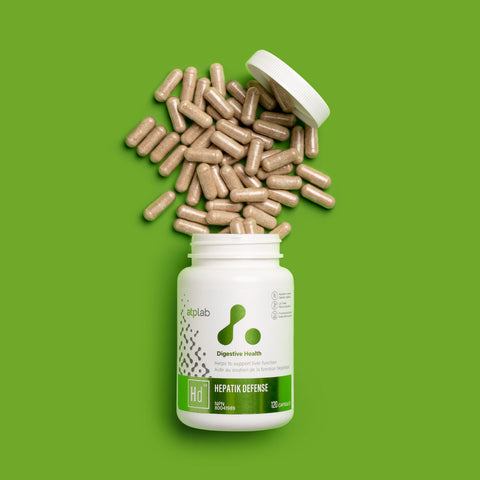 Hepatik Defense Supplement bottle by ATP Lab with capsules spilling out on a green background available Healthsupp